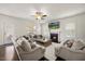 Comfortable living room featuring a ceiling fan, a fireplace, hardwood floors, and plush seating arrangements at 175 Hawkesburg Dr, Clayton, NC 27527