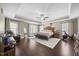 Spacious main bedroom features a tray ceiling, hardwood floors, natural light, and a cozy sitting area at 175 Hawkesburg Dr, Clayton, NC 27527