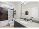 Well-lit bathroom featuring a combination shower and tub with dark bronze fixtures at 175 Stonecrest Way, Pittsboro, NC 27312