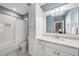White bathroom with blue accent paint featuring a tub and shower combination and storage at 175 Stonecrest Way, Pittsboro, NC 27312