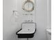 Charming bathroom with a unique sink, classic fixtures, and a porthole-style mirror at 175 Stonecrest Way, Pittsboro, NC 27312
