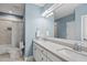Elegant bathroom features a double vanity, decorative mirror, and tiled shower at 175 Stonecrest Way, Pittsboro, NC 27312