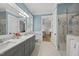Stylish bathroom with double vanity, light blue walls, and modern glass shower stall at 175 Stonecrest Way, Pittsboro, NC 27312