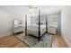 Beautiful bedroom features a four-poster bed, light wood floors, and matching nightstands at 175 Stonecrest Way, Pittsboro, NC 27312