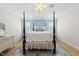 Inviting bedroom featuring a four-poster bed, light blue accent wall, and neutral-toned furnishings at 175 Stonecrest Way, Pittsboro, NC 27312