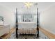 Charming bedroom featuring a four-poster bed, hardwood floors, and stylish decor at 175 Stonecrest Way, Pittsboro, NC 27312