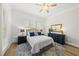 Comfortable bedroom featuring a blue accent rug, white bedding, and dark wood furnishings at 175 Stonecrest Way, Pittsboro, NC 27312