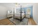 Comfortable primary bedroom with a four-poster bed, blue accent wall, and stylish decor at 175 Stonecrest Way, Pittsboro, NC 27312