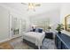 Bright bedroom with white walls, hardwood floors, and french doors to a balcony at 175 Stonecrest Way, Pittsboro, NC 27312