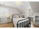 Attic bedroom features natural light from arched window and an ideal reading nook at 175 Stonecrest Way, Pittsboro, NC 27312