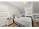 Bedroom with light walls, window nook, and wood floors provides a peaceful space at 175 Stonecrest Way, Pittsboro, NC 27312
