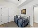 Cozy bedroom features a charming ship painting and a closet with double doors at 175 Stonecrest Way, Pittsboro, NC 27312