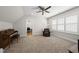 Spacious bonus room features a piano, leather chair, and shuttered windows at 175 Stonecrest Way, Pittsboro, NC 27312