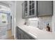 Butler's pantry features gray cabinets, a quartz countertop, and marble backsplash at 175 Stonecrest Way, Pittsboro, NC 27312