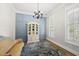 Stylish dining room featuring blue paneled walls, chandelier, and hardwood floors at 175 Stonecrest Way, Pittsboro, NC 27312