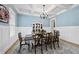 Beautiful dining room with coffered ceilings, wood floors, and blue accent walls at 175 Stonecrest Way, Pittsboro, NC 27312