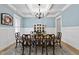 Elegant dining room featuring wainscoting, coffered ceilings, and a stylish chandelier at 175 Stonecrest Way, Pittsboro, NC 27312