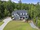 A charming two-story home with black shutters, a manicured lawn, and lovely landscaping at 175 Stonecrest Way, Pittsboro, NC 27312