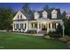 Charming two-story home with inviting entrance, manicured lawn, and blooming flowers at 175 Stonecrest Way, Pittsboro, NC 27312