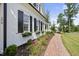 Side view of house with brick pathway and lush landscaping at 175 Stonecrest Way, Pittsboro, NC 27312
