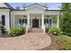 Inviting covered porch with brick flooring, white railings, and detailed trim work at 175 Stonecrest Way, Pittsboro, NC 27312