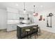 Charming kitchen boasts an island with seating, stainless steel appliances, and bright, neutral finishes at 175 Stonecrest Way, Pittsboro, NC 27312