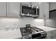 Close up on the kitchen features stainless steel microwave and stove and granite countertops at 175 Stonecrest Way, Pittsboro, NC 27312