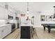 Stylish kitchen showcases an island with seating and is adjacent to a fun rec area with a pool table at 175 Stonecrest Way, Pittsboro, NC 27312