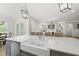 Open-concept kitchen with large island, farmhouse sink, stainless appliances, and seamless flow to the living area at 175 Stonecrest Way, Pittsboro, NC 27312