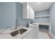 Clean laundry room with modern washer and dryer, sink, and ample storage at 175 Stonecrest Way, Pittsboro, NC 27312