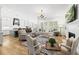 Bright, open-concept living room showcasing hardwood floors and a cozy fireplace at 175 Stonecrest Way, Pittsboro, NC 27312