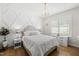 Inviting bedroom features an elegant bed, chandelier, and shuttered windows at 175 Stonecrest Way, Pittsboro, NC 27312