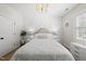 Inviting bedroom features an elegant bed, chandelier, and shuttered windows at 175 Stonecrest Way, Pittsboro, NC 27312