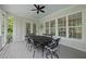 Covered porch with a dining table and a ceiling fan overlooking the backyard at 175 Stonecrest Way, Pittsboro, NC 27312