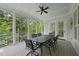 Screened porch with a dining table and a ceiling fan overlooking the backyard at 175 Stonecrest Way, Pittsboro, NC 27312