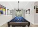 Well-lit rec room with pool table for entertainment with overhead light, perfect for relaxing at 175 Stonecrest Way, Pittsboro, NC 27312
