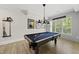 Spacious rec room features a pool table with bright lighting and room to gather and have fun at 175 Stonecrest Way, Pittsboro, NC 27312