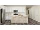 Bright, modern kitchen boasts stainless appliances and a spacious island with bar stool seating at 180 Digging Time Ave, Princeton, NC 27569