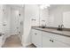 Modern bathroom featuring double vanity with gray countertop and glass enclosed shower with black hardware at 1812 Gazania Dr, Fuquay Varina, NC 27526