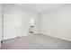 Spacious bedroom with closet doors, neutral carpet and a doorway to a bathroom at 1812 Gazania Dr, Fuquay Varina, NC 27526