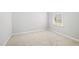 Neutral carpeted bedroom, featuring white walls, and a window with blinds at 1812 Gazania Dr, Fuquay Varina, NC 27526