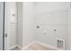 A tidy laundry room with tile floors, wire shelving, and utility hookups at 1812 Gazania Dr, Fuquay Varina, NC 27526