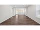 Bright living room with hardwood floors, multiple windows, and a sliding door to a screened porch at 1812 Gazania Dr, Fuquay Varina, NC 27526