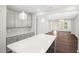 Open floor plan featuring gray cabinets, white countertops, an island, and a view into the living room at 1812 Gazania Dr, Fuquay Varina, NC 27526