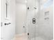 Bright shower with white tile, glass door, matte black hardware and tiled toiletry shelf at 1812 Gazania Dr, Fuquay Varina, NC 27526