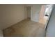 Standard bedroom featuring neutral carpet and white walls. Open closet shown at 1819 Collier Rd, Durham, NC 27707