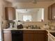 Well-lit kitchen featuring an electric range, generous countertop, and wood cabinetry at 1819 Collier Rd, Durham, NC 27707