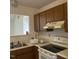 Efficient kitchen includes ample cabinetry, durable countertops, and modern electric appliances at 1819 Collier Rd, Durham, NC 27707