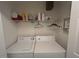 Functional laundry area includes a washer, dryer, and convenient overhead shelving for storage at 1819 Collier Rd, Durham, NC 27707
