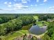 Aerial view of community with golf course, lake, and wooded area at 20 Nicklaus Way, Clayton, NC 27520